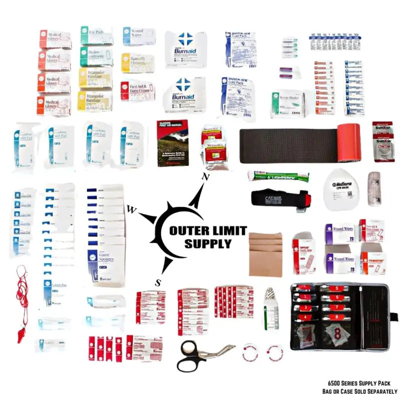 First aid kit with rolled gauze and elastic patch bandages near compass logo