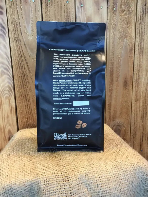 Black bag of roasted coffee beans for Cinnamon Rum Pecan flavored coffee product