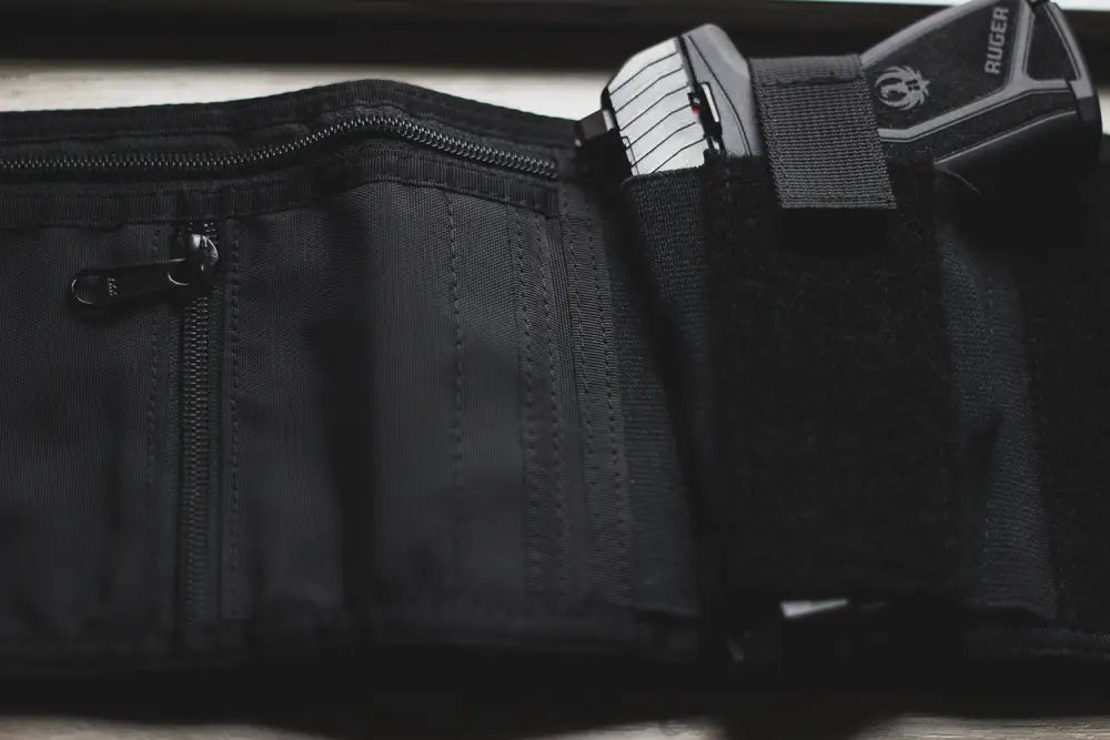 Black nylon fanny pack with gun holster, ideal accessory for first responders and police