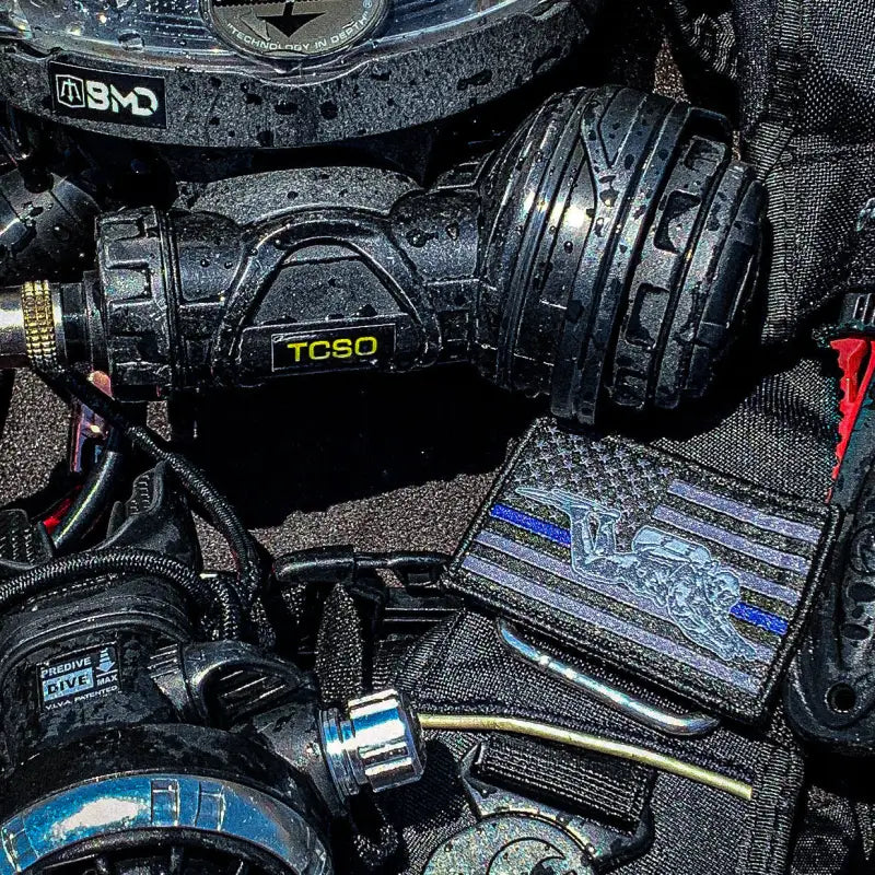 Black scuba diving regulator attached to BMD Slap Straps with Solas Tape for first responders