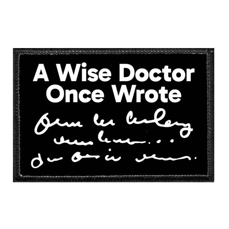 Black removable patch with white text A Wise Doctor Once Wrote and illegible handwriting