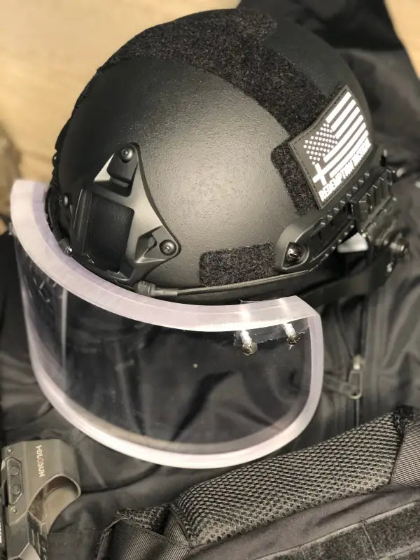 Black tactical helmet with clear ballistic face shield for redemption tactical body armor