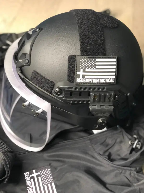 Black tactical helmet with face shield for Body Armor by Redemption Tactical