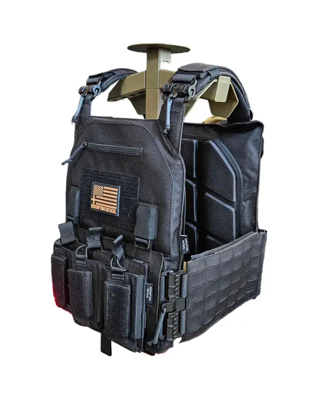 Black tactical plate carrier with magazine pouches and American flag patch by Redemption Tactical
