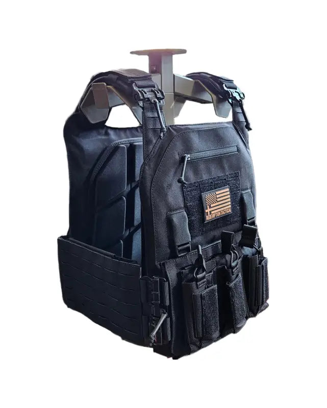 Black tactical plate carrier with magazine pouches and American flag patch from Redemption Tactical