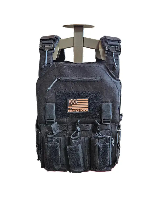 Black tactical plate carrier with pouches and American flag patch from Redemption Tactical