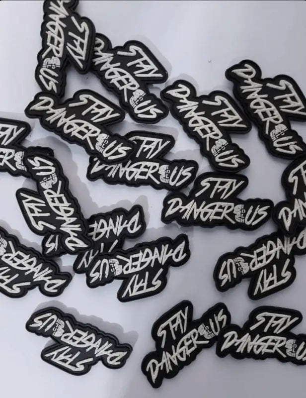 Black and white Stay Dangerous PVC patch for gear and vests, ideal for first responders