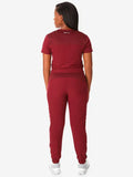 Burgundy athletic jumpsuit back view, highlighting Women’s Tuckable One-Pocket design