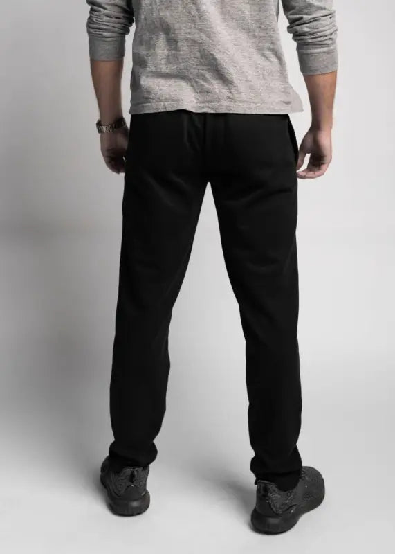 Black straight-leg jeans paired with a grey top showcasing Carrier Sweatpants - Midnight Black
