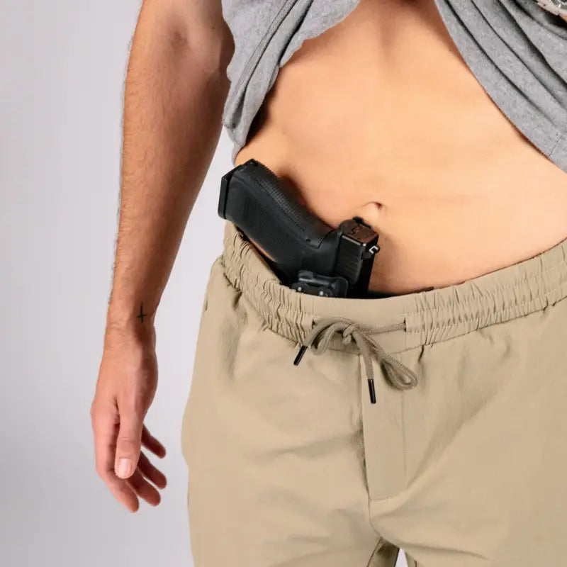 Concealed handgun in waistband of Carrier Traveler Joggers with carrier retention waistband