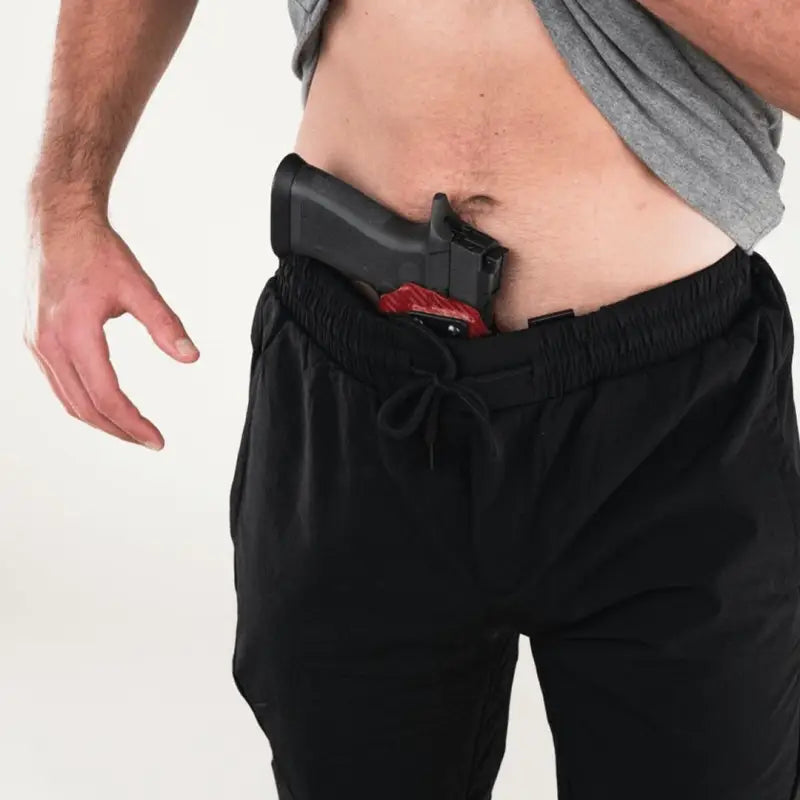 Concealed handgun in waistband of Carrier Traveler Joggers with carrier retention waistband