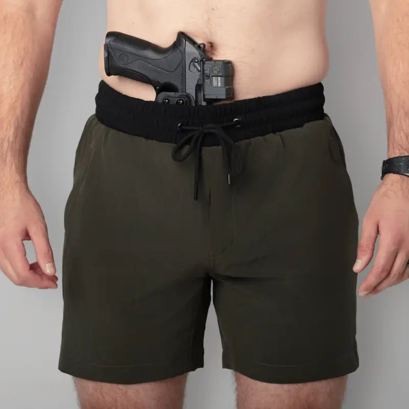 Concealed handgun in waistband of Carrier Training Shorts Mk.II for concealed carry