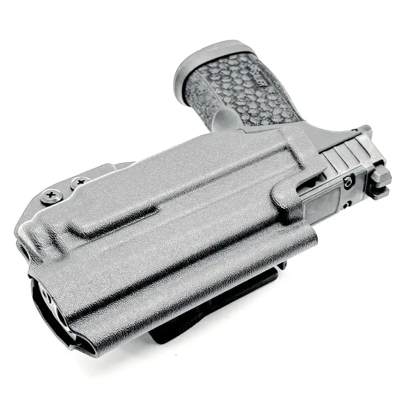 Dark gray Sig Sauer P365-FUSE pistol in matching holster with light mounted for concealed carry