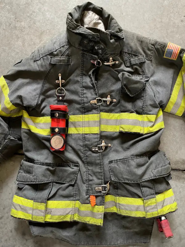 Firefighter’s gray turnout coat with THE MINIMALIST Leather Inverted flashlight holder