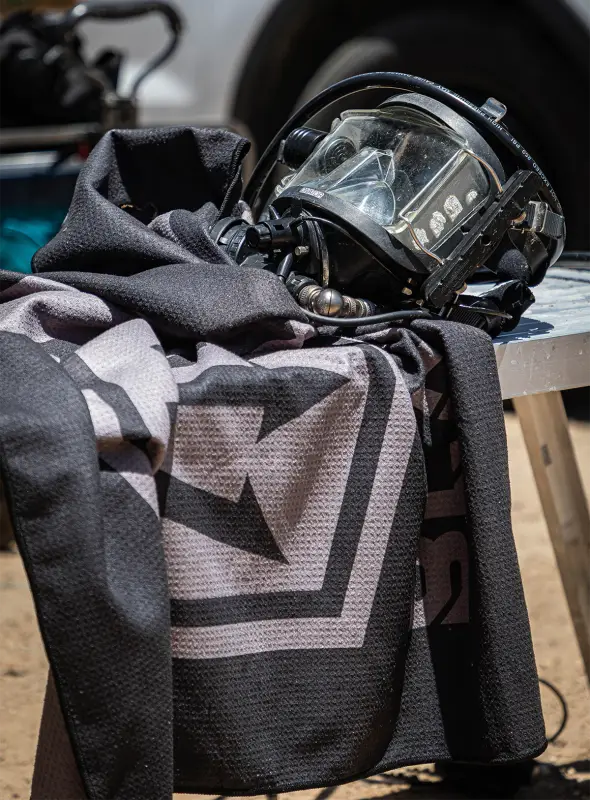 Firefighter’s helmet and patterned towel from Tek Towel dive kit for remote dive sites