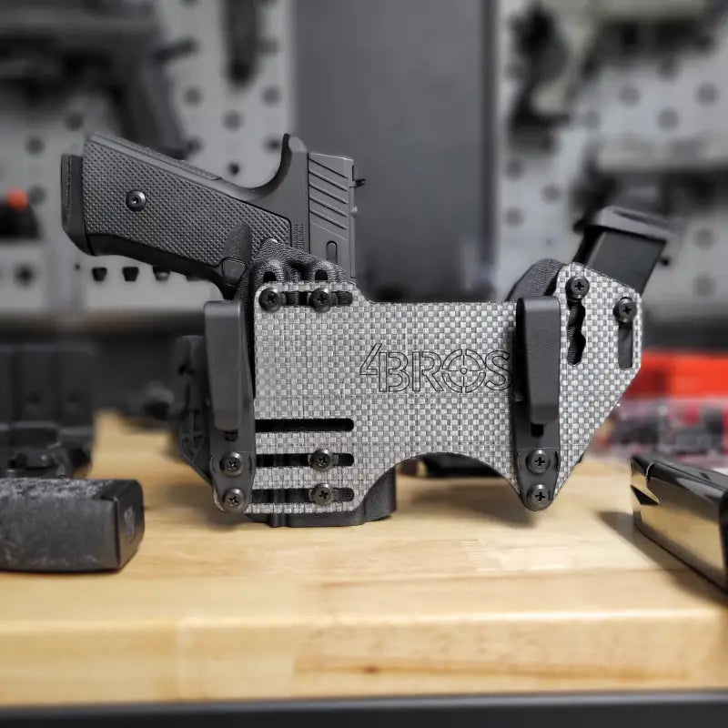 Gray carbon fiber gun holster on 4BROS Fat Guy’s Appendix Rig with magazine carrier