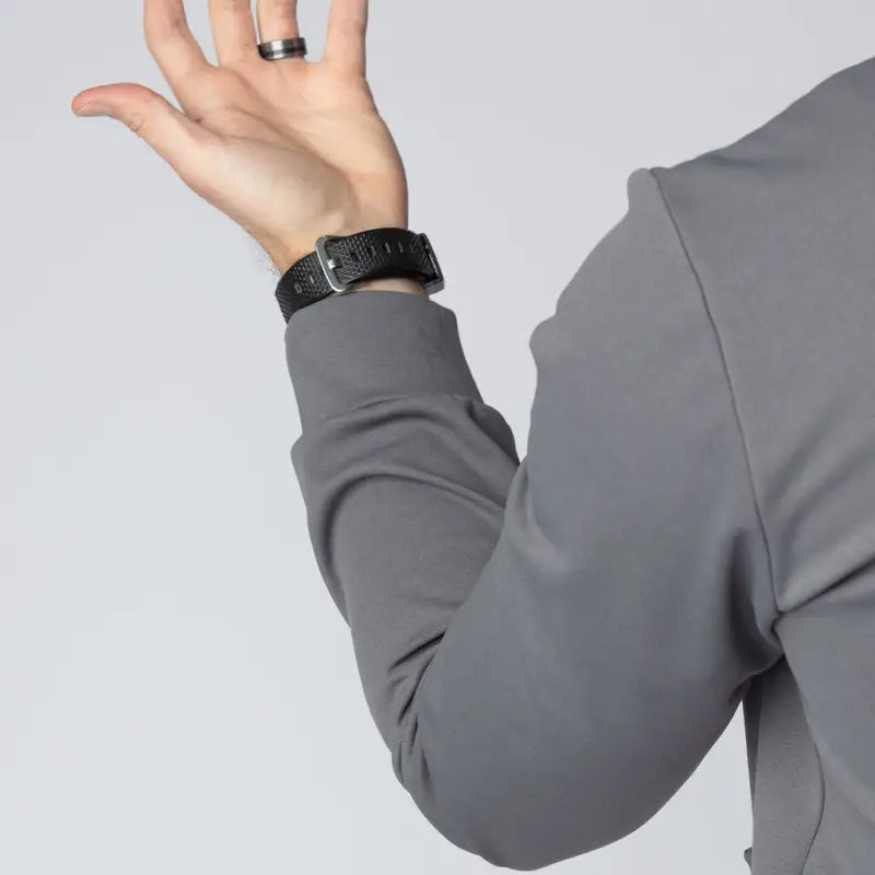 Gray long-sleeved shirt with black watch showcases Durable Concealment Hoodie with hand pocket