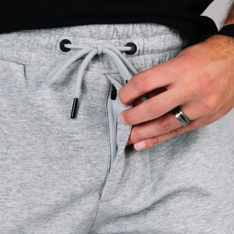 Gray drawstring sweatpants with patented carrier retention waistband for comfortable wear