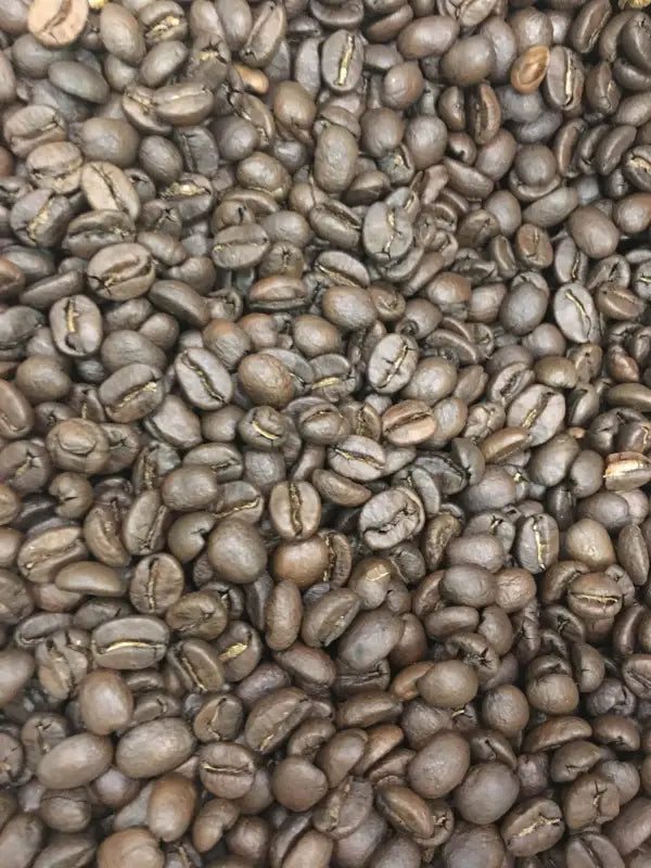 Heap of medium-roast coffee beans from Southern Star Bourbon Infused Costa Rica