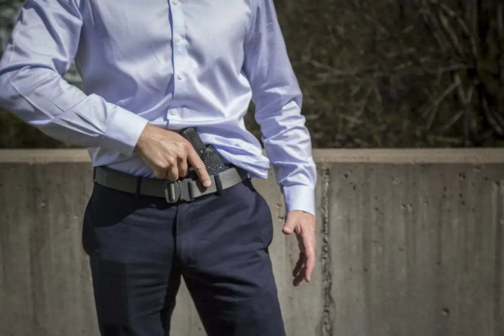 Handgun in IWB Holster Kit worn with dress pants and blue shirt, fits Beretta