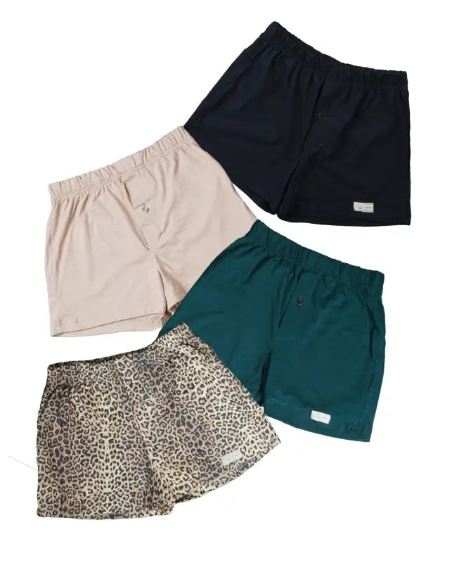 Four pairs of boxer shorts in black, beige, green, and leopard print patterns