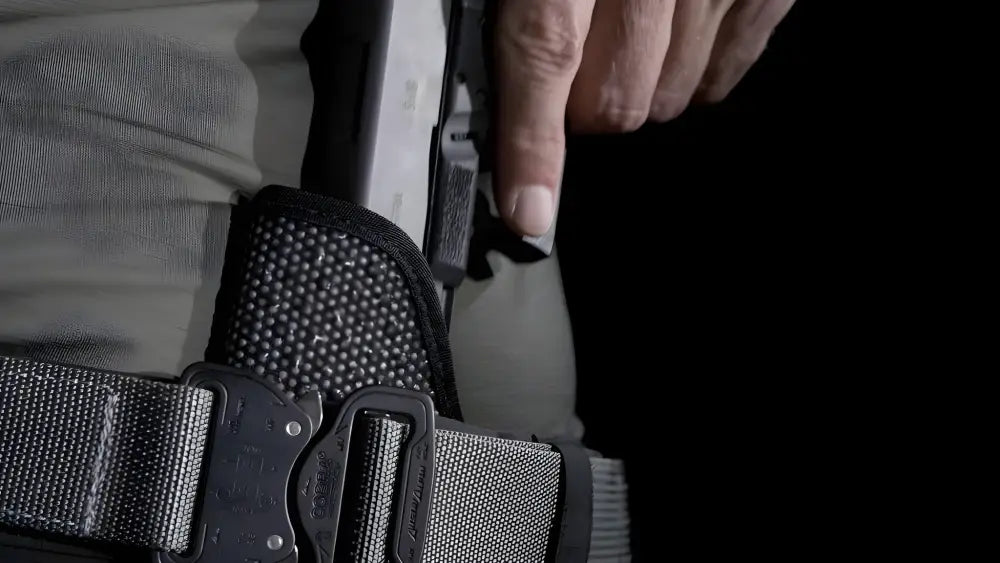 Black handgun in Mainstay Clipless IWB Holster made of mesh material