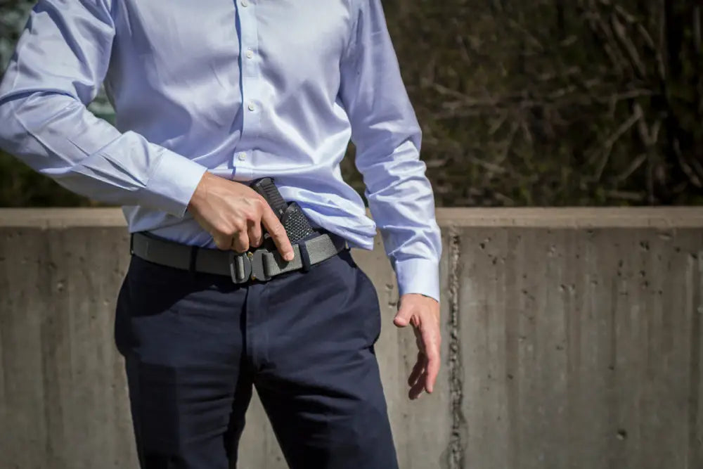 Black handgun in Mainstay Clipless IWB Holster with dress pants and shirt