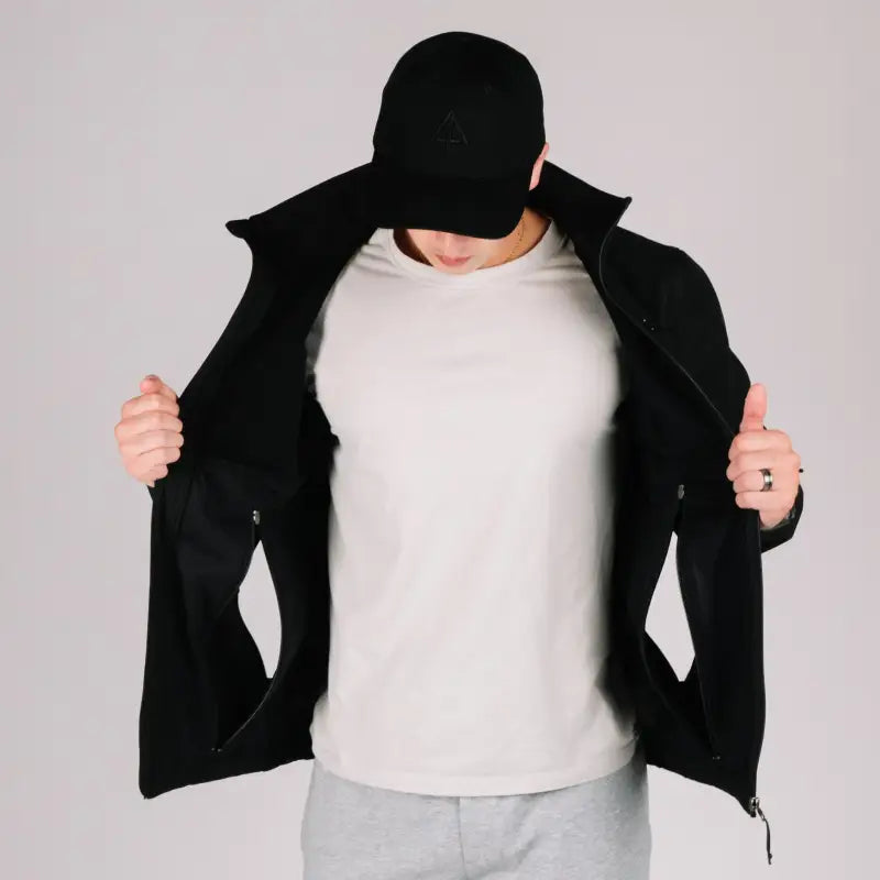 Man in black tactical jacket Bravo with hand pocket showcasing durable tactical jacket style
