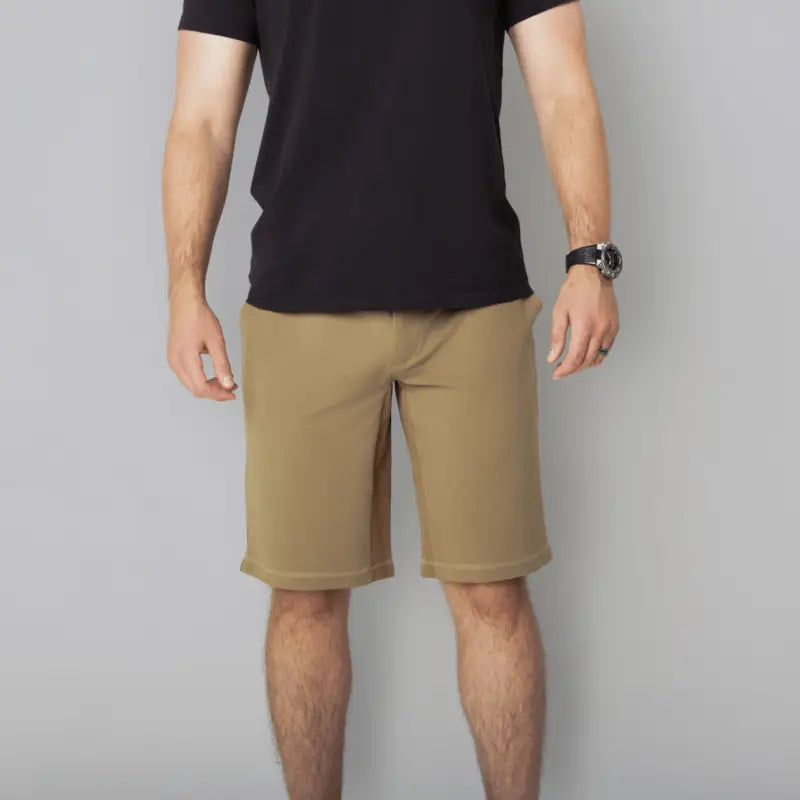 Man wearing black T-shirt and khaki Carrier Shorts Mk.II for concealed carry in Arrowhead Tactical Apparel