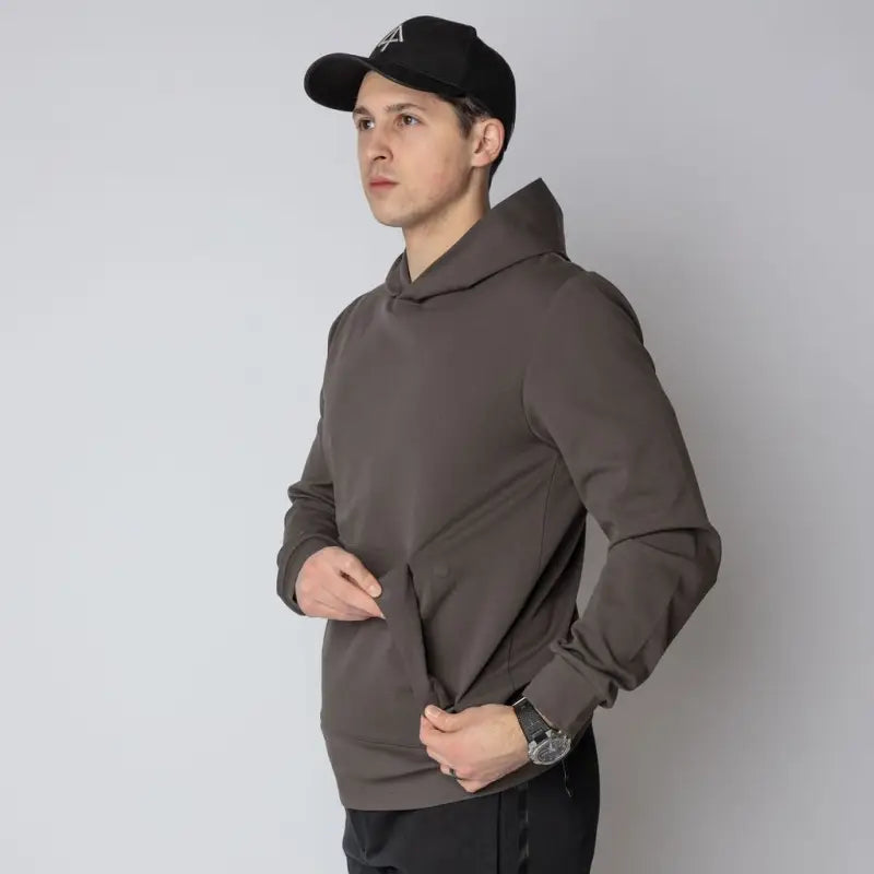Man in Durable Concealment Hoodie with hand pocket and smooth draws wearing brown hoodie
