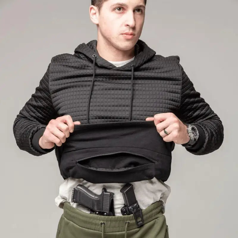 Man demonstrating concealed carry in hand pocket of Standoff Concealment Hoodie Mk.II