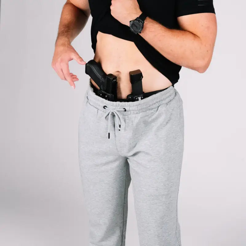 Man with concealed firearms in Carrier Sweatpants Mk.II featuring patented carrier retention waistband