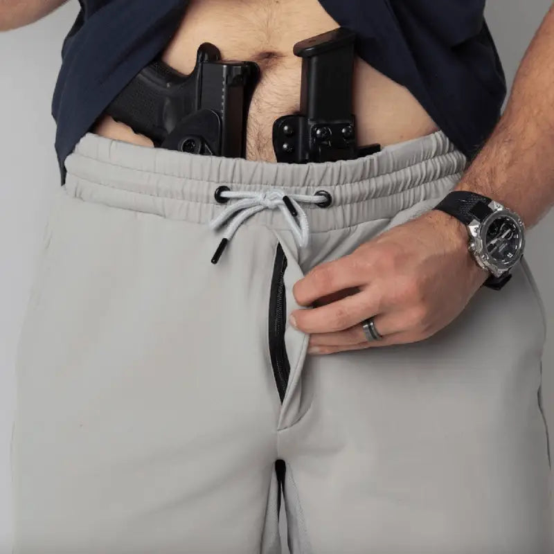 Man with concealed handgun and magazine wearing Carrier Shorts Mk.II for concealed carry