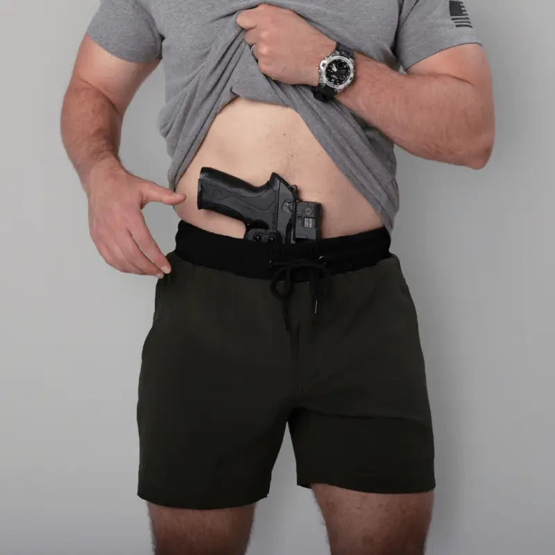 Man with gun in waistband wearing Carrier Training Shorts Mk.II for concealed carry
