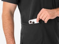 Hand placing googly eyes into pocket of Men’s Five-Pocket Scrub Top