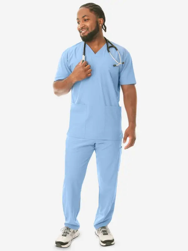 Healthcare worker in light blue medical scrubs showcasing Men’s Five-Pocket Scrub Top