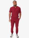 Burgundy men’s five-pocket scrub set paired with gray sneakers for a stylish look