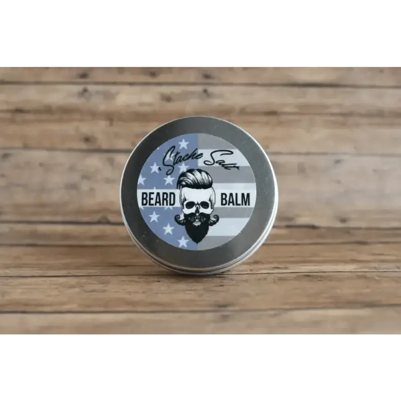 Metal tin of Ol’ Fashion Beard Balm featuring skull logo and stars and stripes design