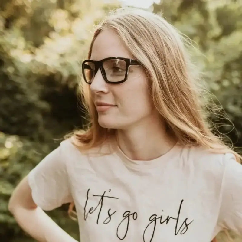 Person in glasses and white t-shirt showcasing Metel M40 Safety Glasses with polycarbonate lenses