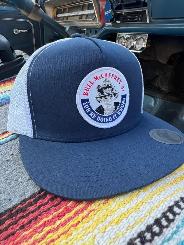 Navy blue and white Bull Truckee mesh hat with circular logo patch for first responders