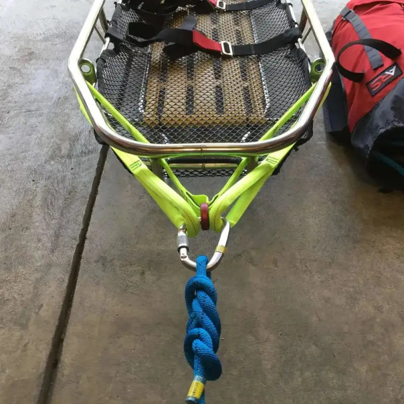Neon green boat trailer with a braided blue rope and Multi-Loop Rescue Strap attached