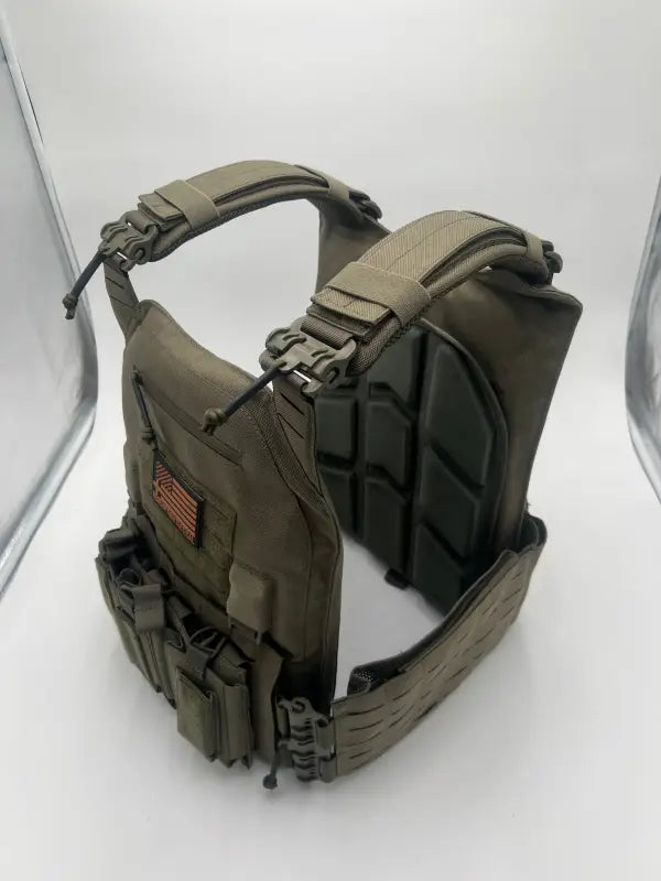 Olive drab tactical vest with modular attachments and padded shoulder straps for large size body armor