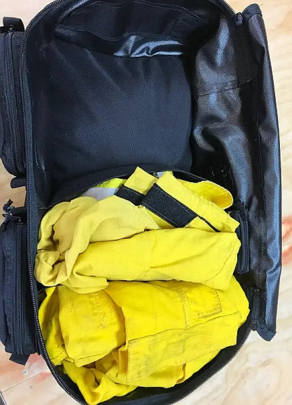 Open black Wildland Fire Gear Bag 2 Compartment with suede leather wrap and yellow clothing