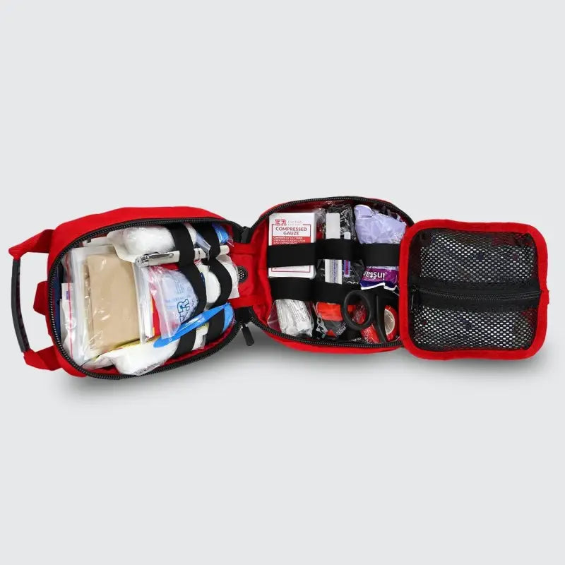 Open red first aid kit for first responders and firefighters featuring the Small Rip-Away Tactical Trauma Kit