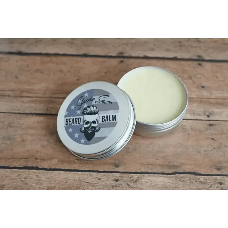 Open tin of Ol’ Fashion Beard Balm featuring a skull logo design on the lid
