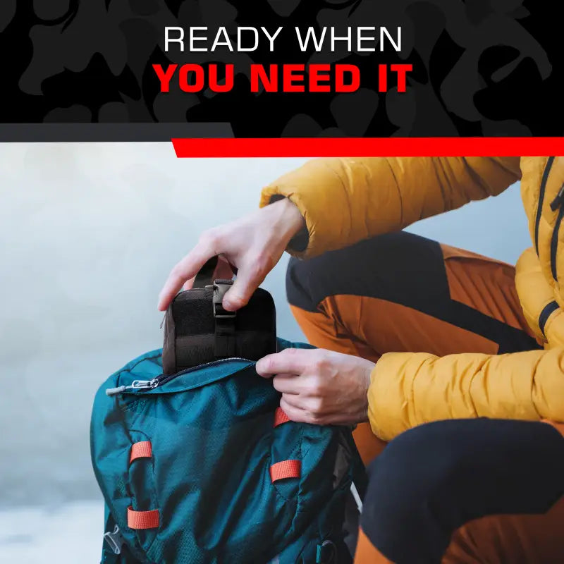 Person packing Trauma IFAK Kit into blue backpack for first responders, firefighters, police