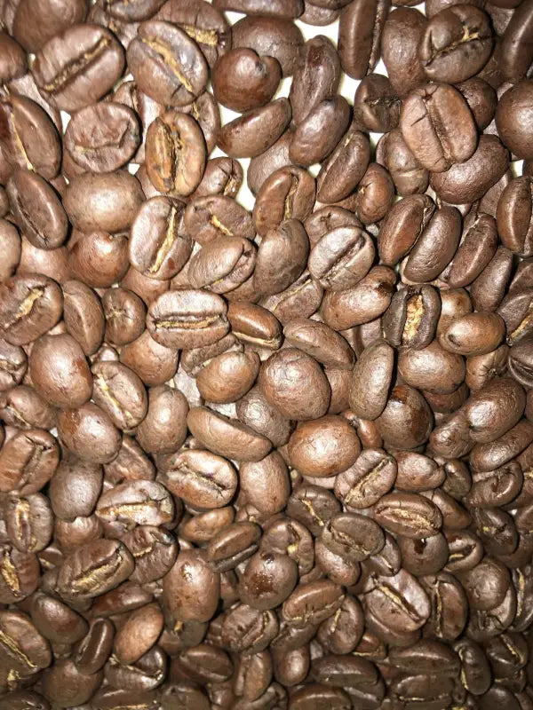 Pile of roasted bourbon infused coffee beans from Costa Rica for Bourbon Infused Coffee product