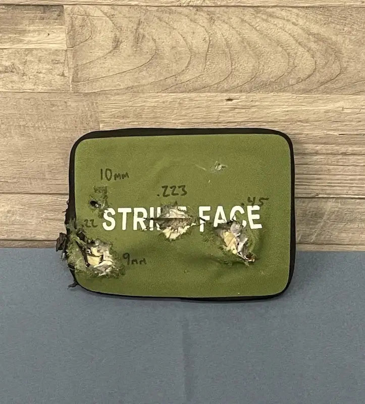 Olive green body armor panel with bullet impacts for Level III protection by Redemption Tactical