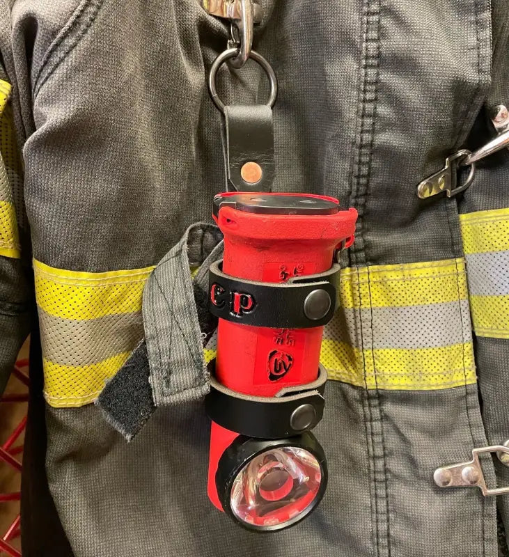 Red flashlight with black straps in THE MINIMALIST Leather Inverted Flashlight Holder