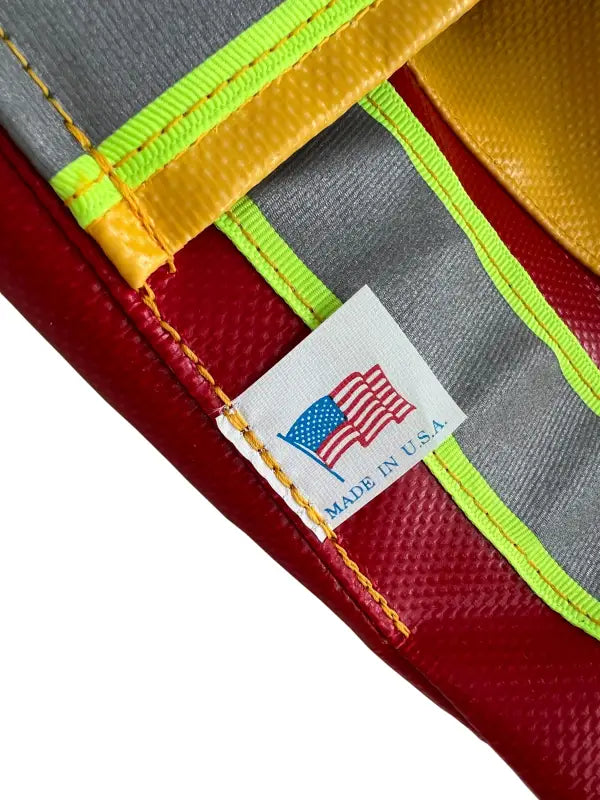 ElkHart Brass weather nozzle cover with red, yellow, and gray materials and Made in U.S.A. tag